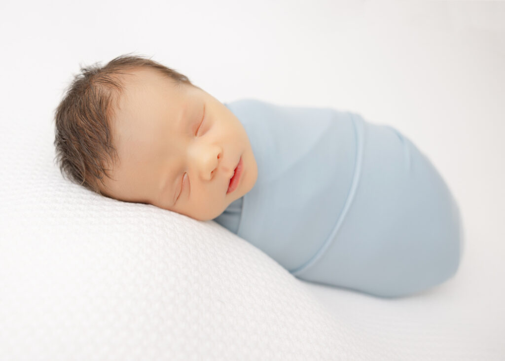 newborn sleeping soundly for his first photo op!