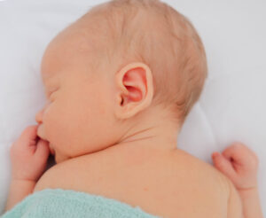 Baby boy sleeping on stomach asleep for photo shoot